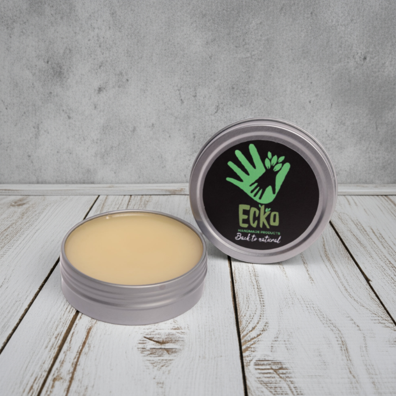 Cosmetic balm in a metal container with 'Ecko' branding on a wooden surface.